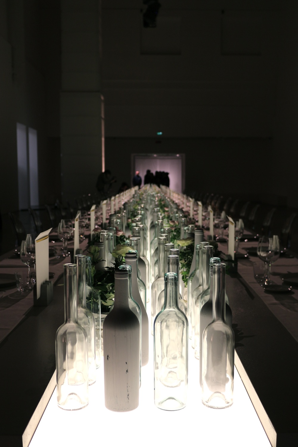 la “scenografia” del Convivio, la cena riservata a 44 ospiti; sul tavolo, sopra una banda luminosa, oltre 600 bottiglie